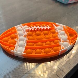 Orange and White Football Pop It Toy